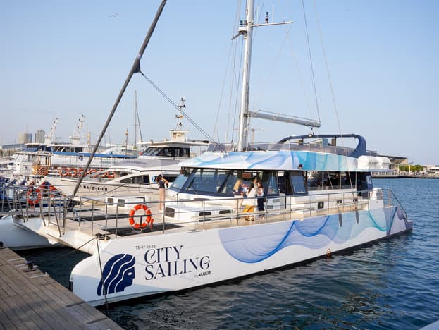 Catamarán City Sailing atracado en el puerto deportivo con pasajeros a bordo
